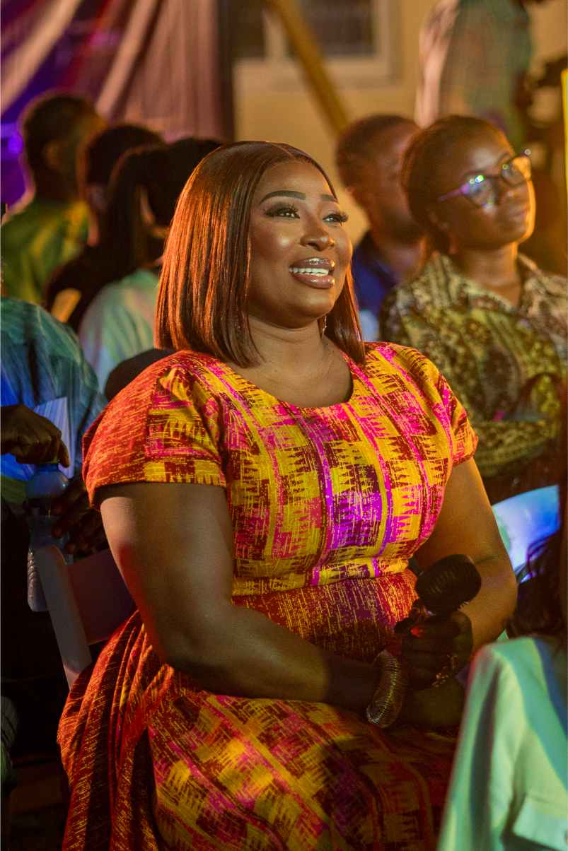 Audience member in kente at REFFA