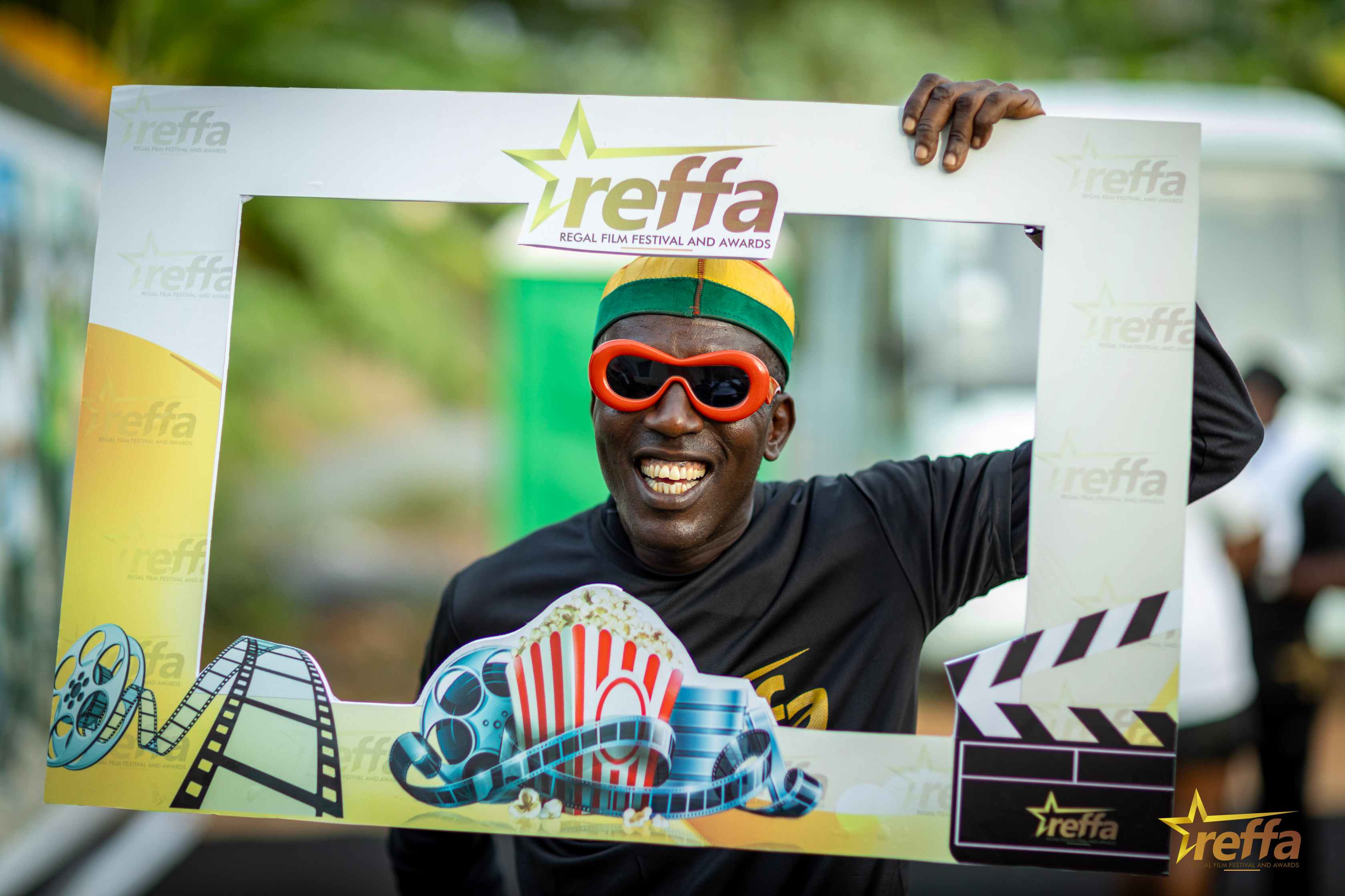 Participant posing in a REFFA photo frame