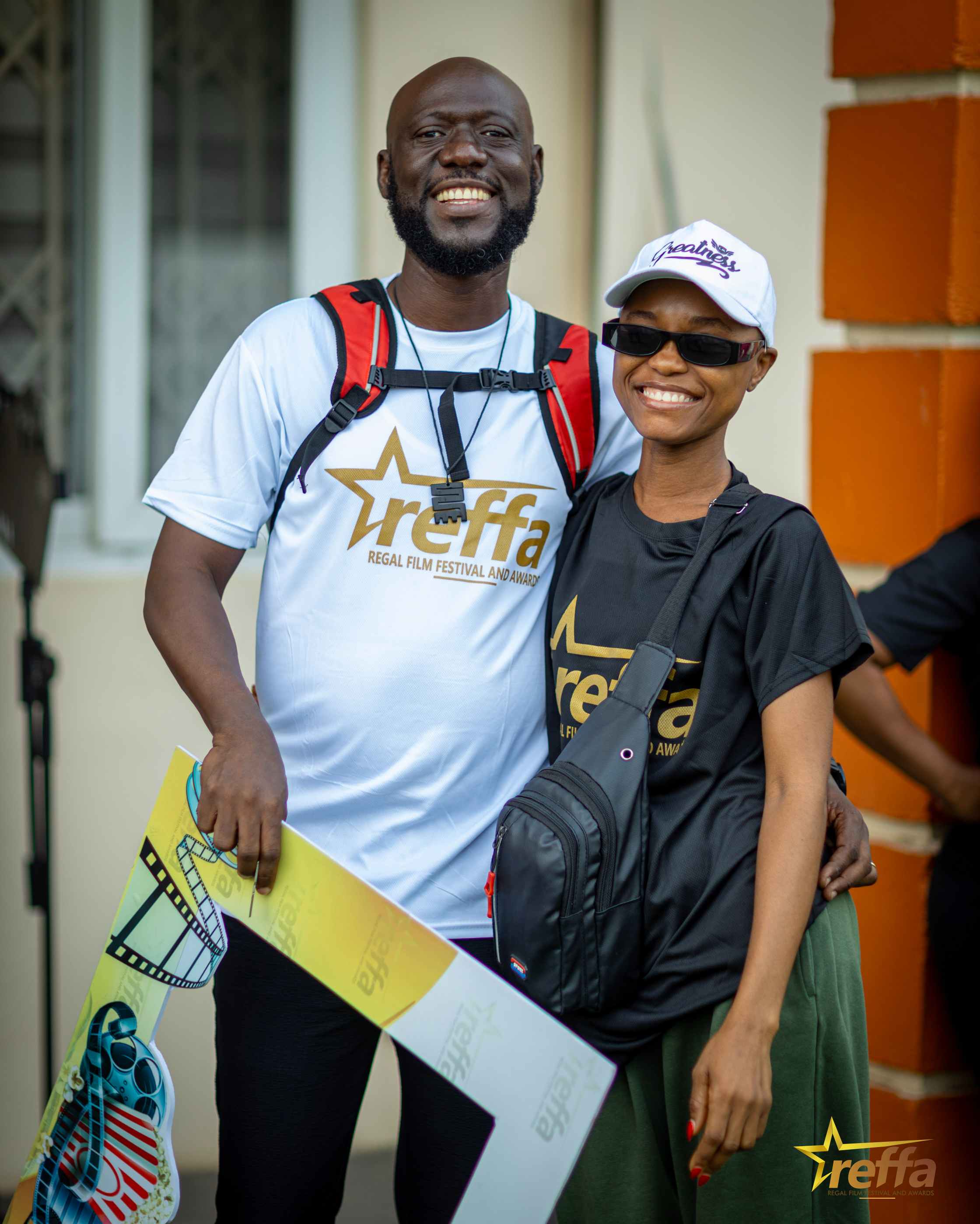 Two friends posing with REFFA props